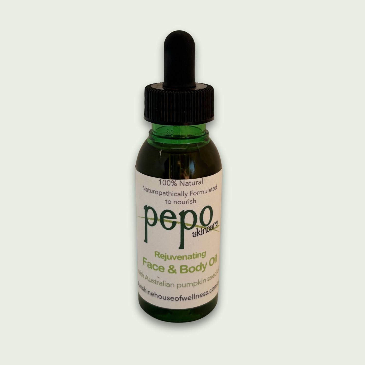 Bottle of pepo natural skincare rejuvenating face and body oil on a light gray background