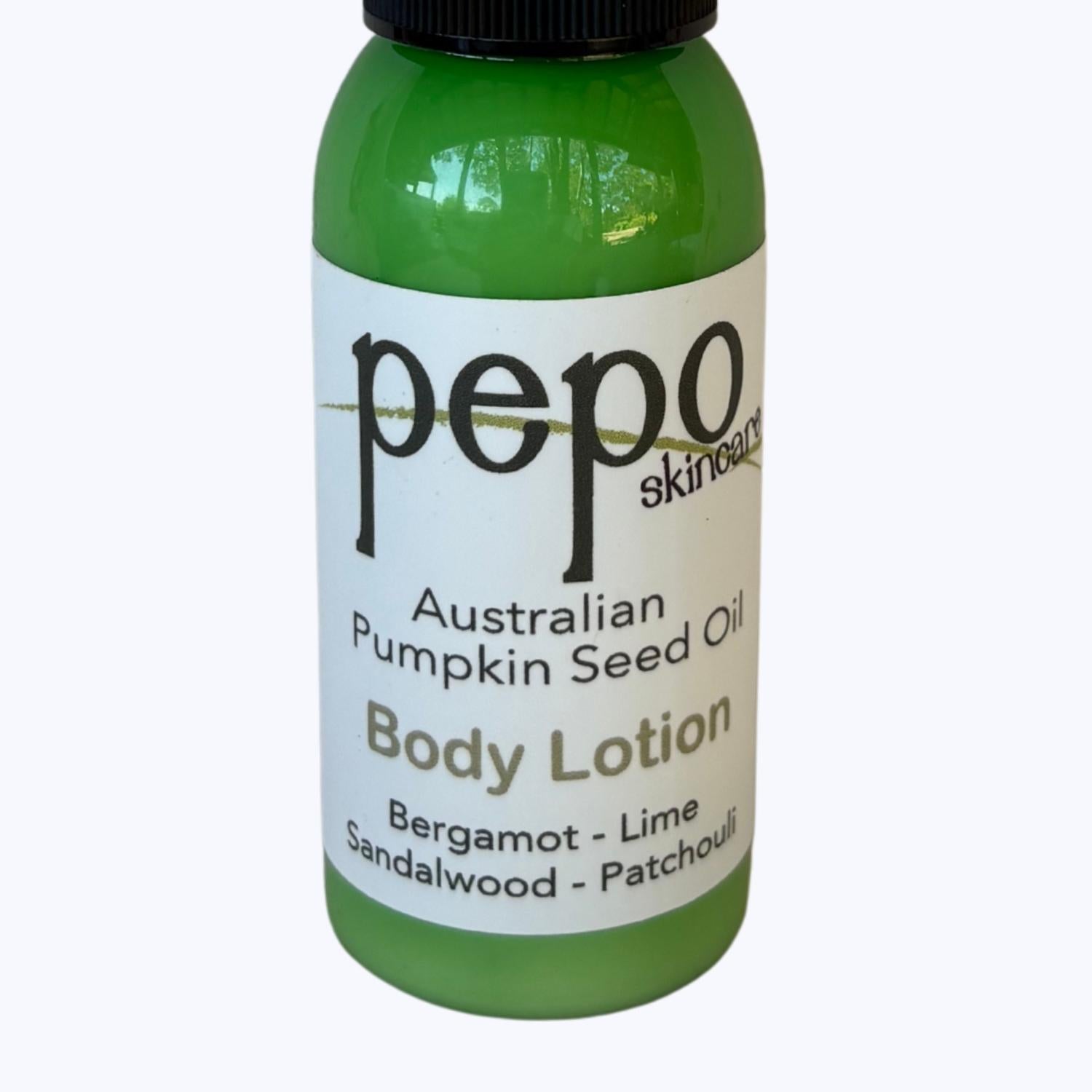 Green bottle of Pepo natural Australian Pumpkin Seed Oil Body Lotion on a white background