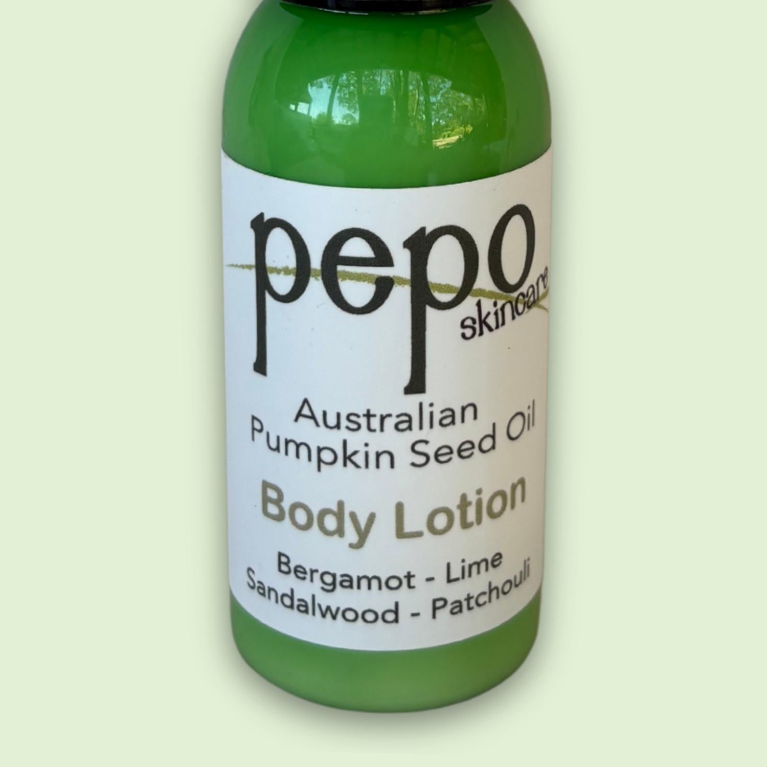 Green bottle of pepo skincare Australian Pumpkin Seed Oil natural Body Lotion on a light green background